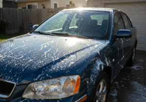 A car completely drenched in water, illustrating common mistakes to avoid when detailing your vehicle.