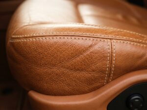 Close up premium automotive leather seat surface showing natural grain texture