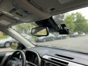 Dual channel dash cam front and rear units installed in vehicle with clean wiring
